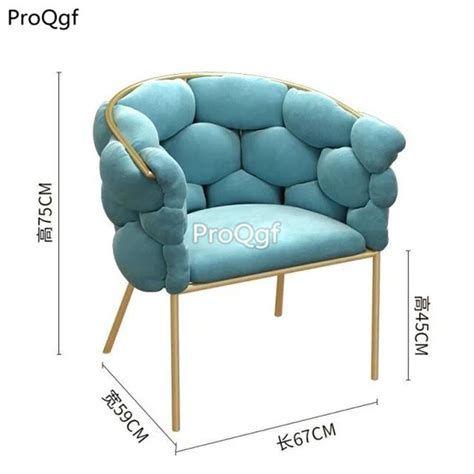 A Blue Chair With Gold Trimmings On The Back And Arms Sitting In Front