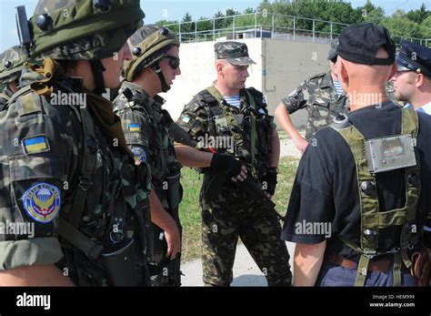 Ukrainian Ground Forces Troops Speak With Romanian Land Forces Soldiers