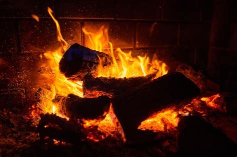 Premium Photo | Burning logs in the fireplace