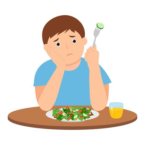 Cute kid do not want eat salad. A sad child is sitting at the table