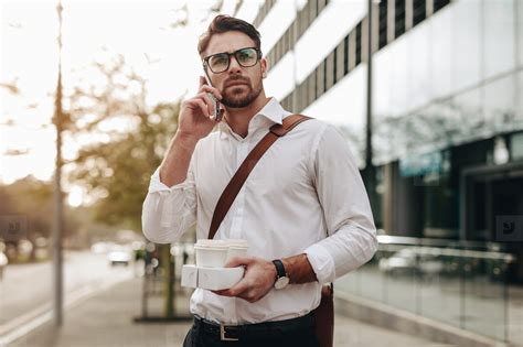 Man talking on cell phone while walking on street stock photo (157317 ...