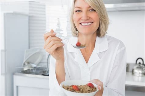 Premium Photo Smiling Blonde Eating Cereal For Breakfast