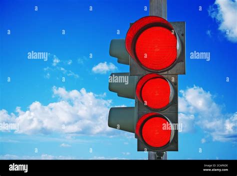 traffic light with three red lights on under a blue sky Stock Photo - Alamy