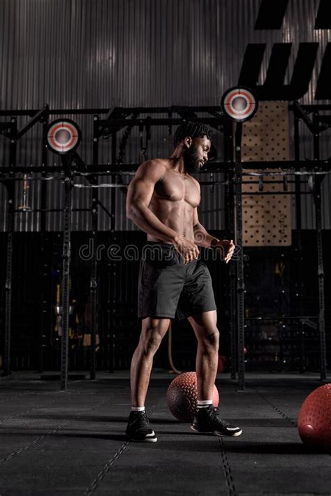 Portrait Of Handsome Muscular Male With Naked Torso Posing Standing After Workout In Gym Stock
