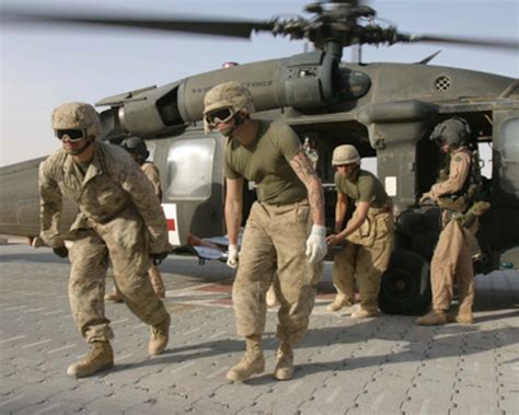 Us Marines Unload A Wounded Marine From An Army Uh 60 Blackhawk