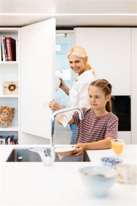 White Mother And Daughter Smiling While Washing Dishes Together Stock Image Image Of Blonde