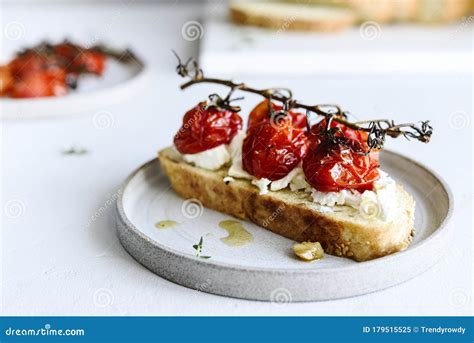 Tomato Confit And Goat Cheese Bruschetta On Grey Concrete Table Stock Image Image Of Grey