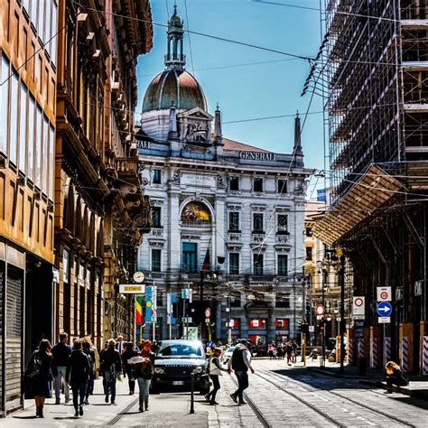 Milan Street Panorama With Milan Trams Pedestrians And Cars On A Sunny