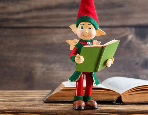 premium ai image  wooden figure   elf holding  open book