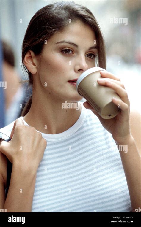 Female Long Brunette Hair In Loose Ponytail Wearing Grey And White Striped Vest Top Blue Denim