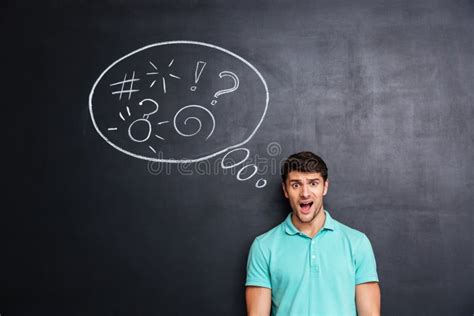 Thoughtful Confused Young Man Standing And Thinking Over Blackboard