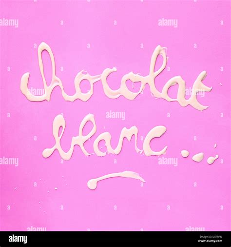 Chocolat Blanc Written With Melted White Chocolate Stock Photo Alamy