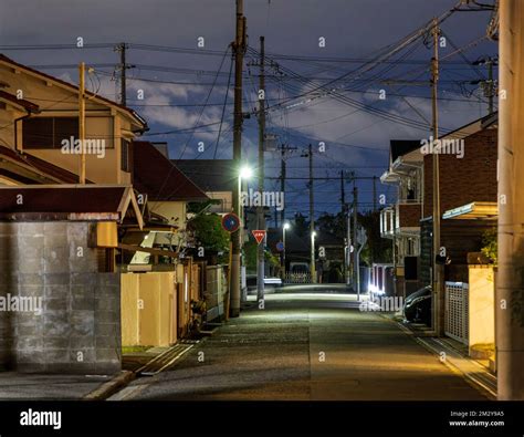 Empty Street Through Quiet Japanese Neighborhood At Night Stock Photo