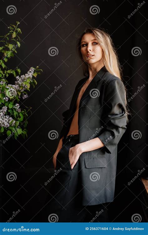 A Blonde Woman In A Black Jacket On A Naked Body In A Dark Room Stock Photo Image Of Bouquet