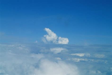 Premium Photo | White clouds against the blue sky seen from the flight ...