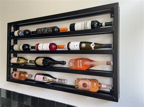 A Wall Mounted Wine Rack Filled With Bottles