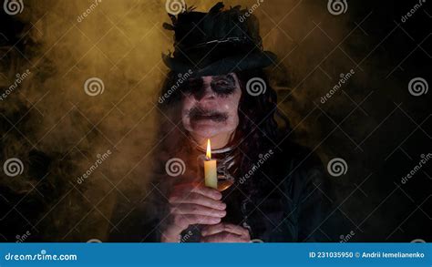 Sinister Old Mature Woman In Carnival Costume Of Halloween Witch Making