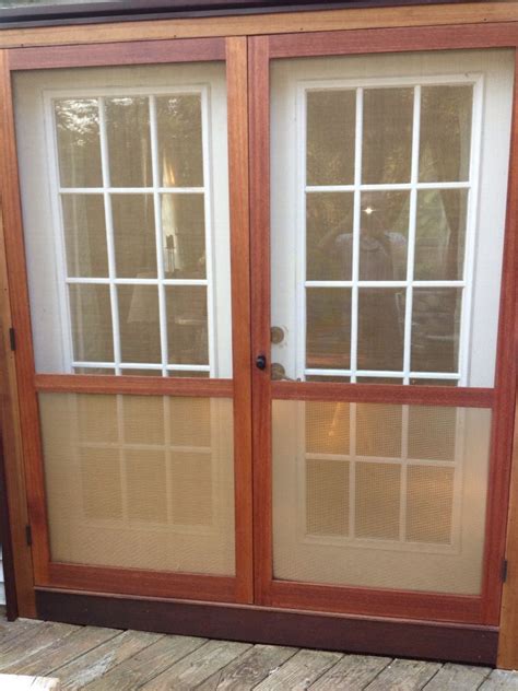 An Open Sliding Glass Door On The Outside Of A House With Wood Flooring And Windows