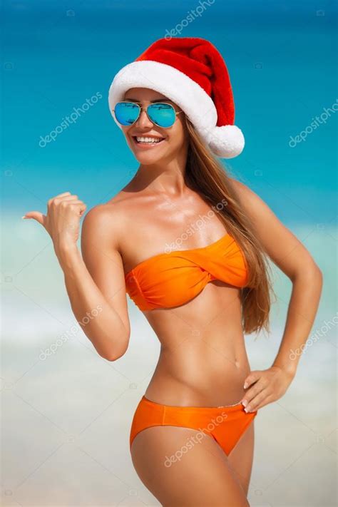 Maiden In Orange Bikini And Hat Of Santa Claus Stock Photo By Golyak