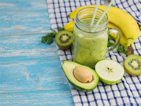 Premium Photo Smoothie Of Avocado Banana Kiwi And Lemon On A Wooden