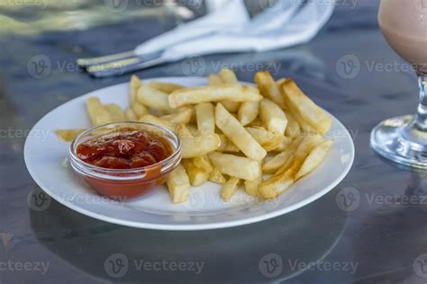 French Fries With Tomato Sauce On White Plate Stock Photo At