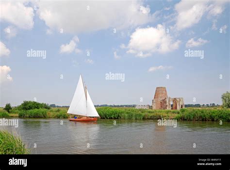 A Yacht In Full Sail Approaching The St Benet S Abbey Ruins On The