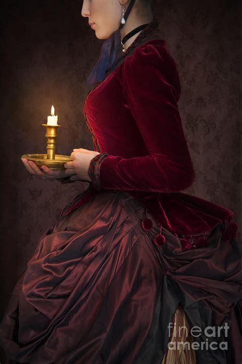 Victorian Woman In A Red Bussle Dress Holding A Candle At Night