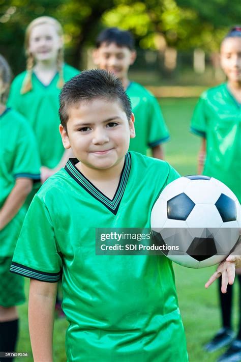 Cute Elementary Age Soccer Player With Coed Team High Res Stock Photo