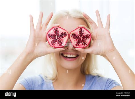 Happy Woman Covering Eyes With Pomegranate Stock Photo Alamy