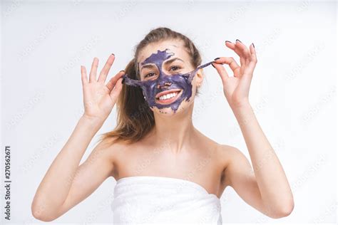 A Beautiful Naked White Girl Years Old Wrapped In A Towel Removes A Violet Cosmetic Mask