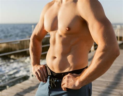 Premium Photo Close Up Naked Torso Of Muscular Man At Sunrise On The Beach