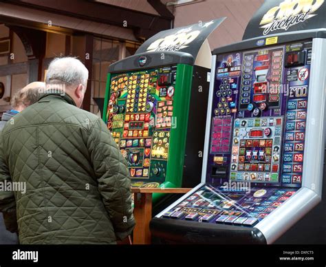 Two Senior Man On A Slot Machine In The Pub Uk Stock Photo Alamy