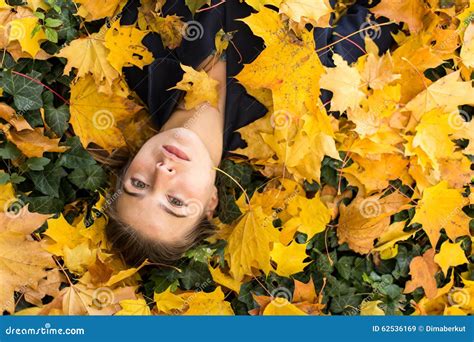 Young Girl Lying In The Autumn Yellow Leaves Stock Image Image Of