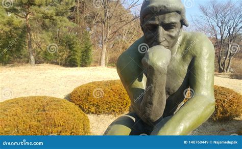 Green Statue Of Thinker Auguste Rodin Setting Naked On A Rock Editorial Stock Image Image Of