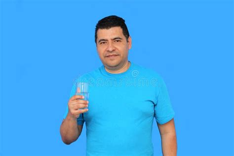Dark Skinned Latino Adult Man Shows His Glass With Water To Hydrate Himself In Hot Weather Stock
