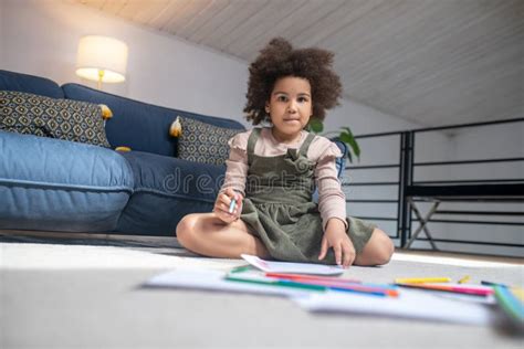 Petite Fille Afro américaine Attentive Avec Crayon Coloré Image stock