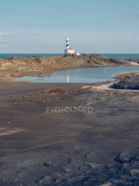 Rocky coast and beacon tower — holiday, travel - Stock Photo | #222710904