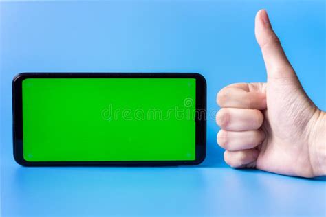 A Smartphone In A Horizontal Position With A Green Screen On A White