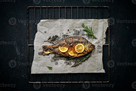 Fish Baked In Oven With Lemon And Rosemary On Parchment Paper Laid Out