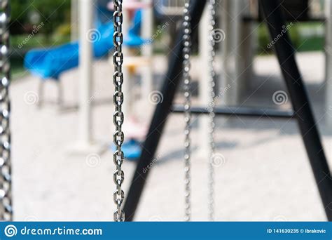 Playground Swing in a Park stock image. Image of plastic - 141630235