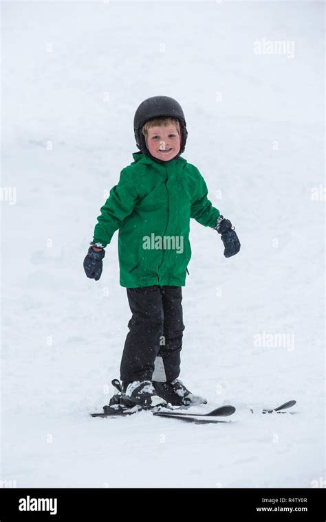 Portrait Smiling Cute Boy Skiing In Snow Stock Photo Alamy