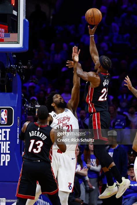 Jimmy Butler of the Miami Heat shoots against Joel Embiid of the ...