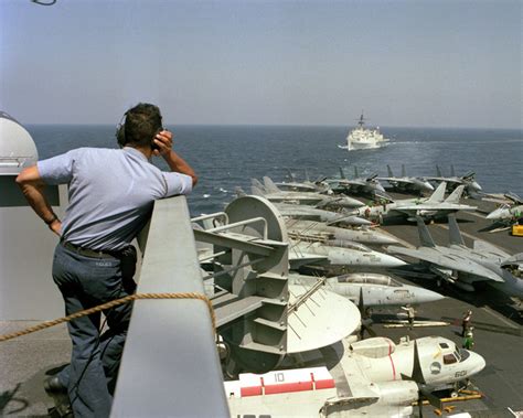 A Crew Member Watches From The Island As The Miscellaneous Flagship USS