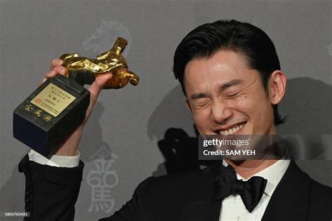 Taiwanese actor Wu Kang-ren displays a trophy after winning the Best ...