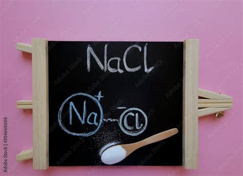 Structural chemical formula of sodium chloride molecule on a black ...