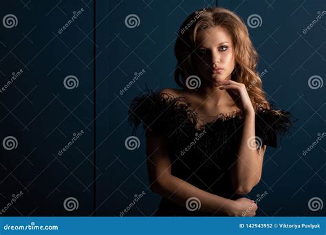 Beautiful Blonde Girl Wearing Black Dress With Naked Shoulders Posing