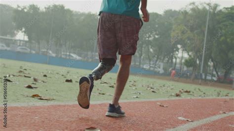 Disabled Athlete Running With Prosthetic Leg At Running Track