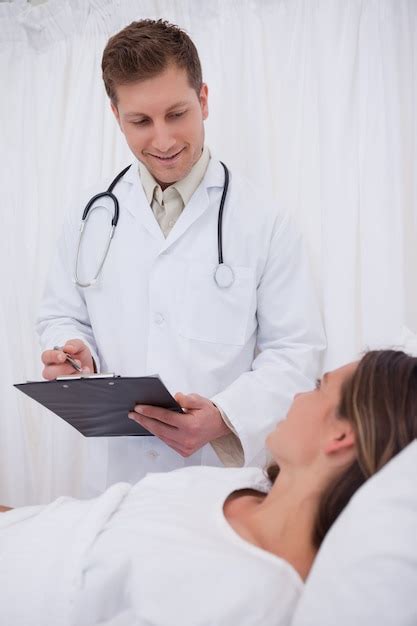 Premium Photo Doctor Standing Next To His Patient