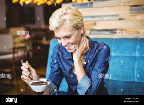 Smiling Blonde Eating A Creamy Chocolate Stock Photo Alamy