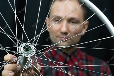 Premium Photo | Bike repair a mechanic holds in his hand the front ...